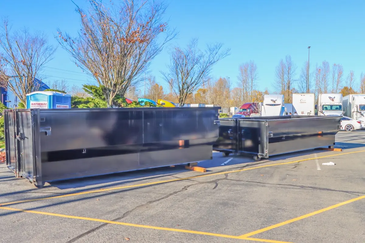 Professional dumpster rental service with roll-off container on residential driveway in North Haledon
